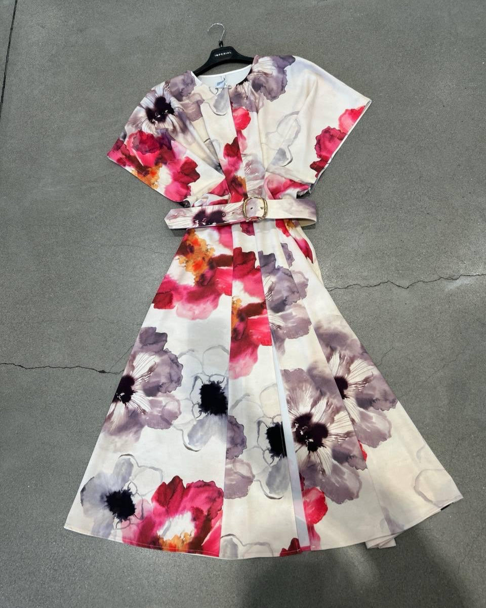 Floral dress on a hanger against a gray background