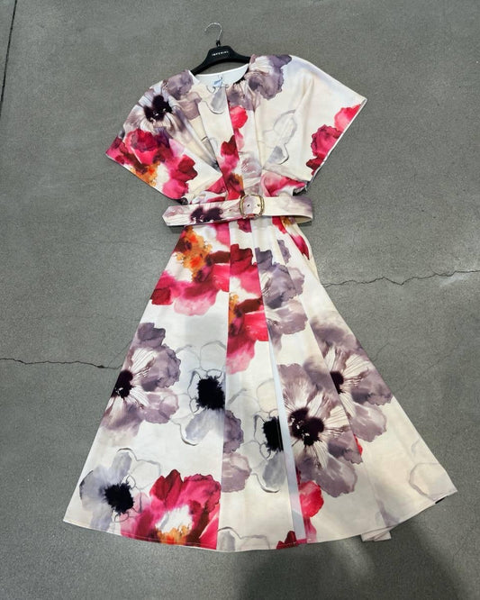 Floral dress on a hanger against a gray background
