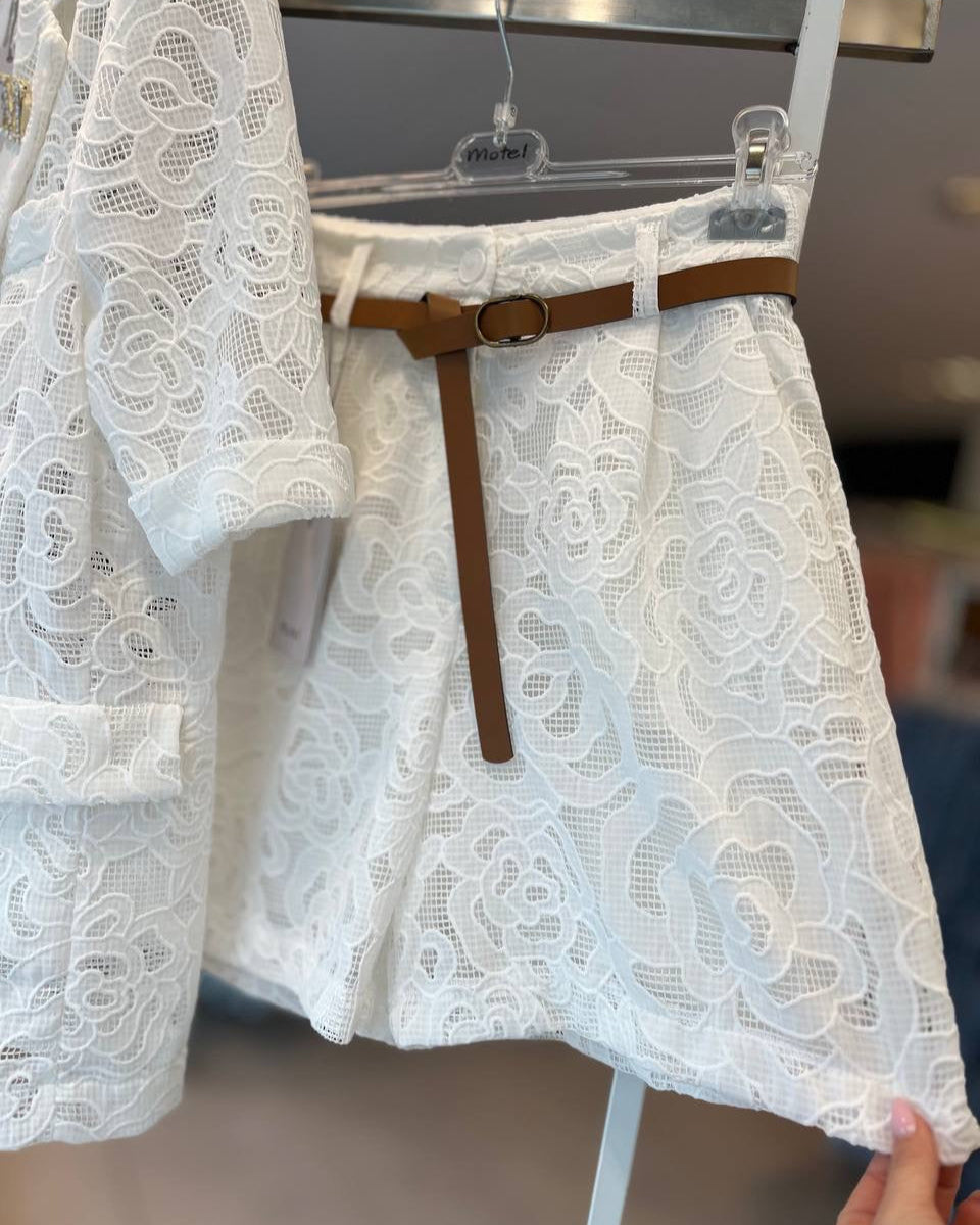 Lace shorts displayed on a hanger, with a brown belt tied around the waist.