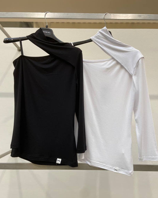 Two tops, one black and one white, displayed on hangers against a neutral background.